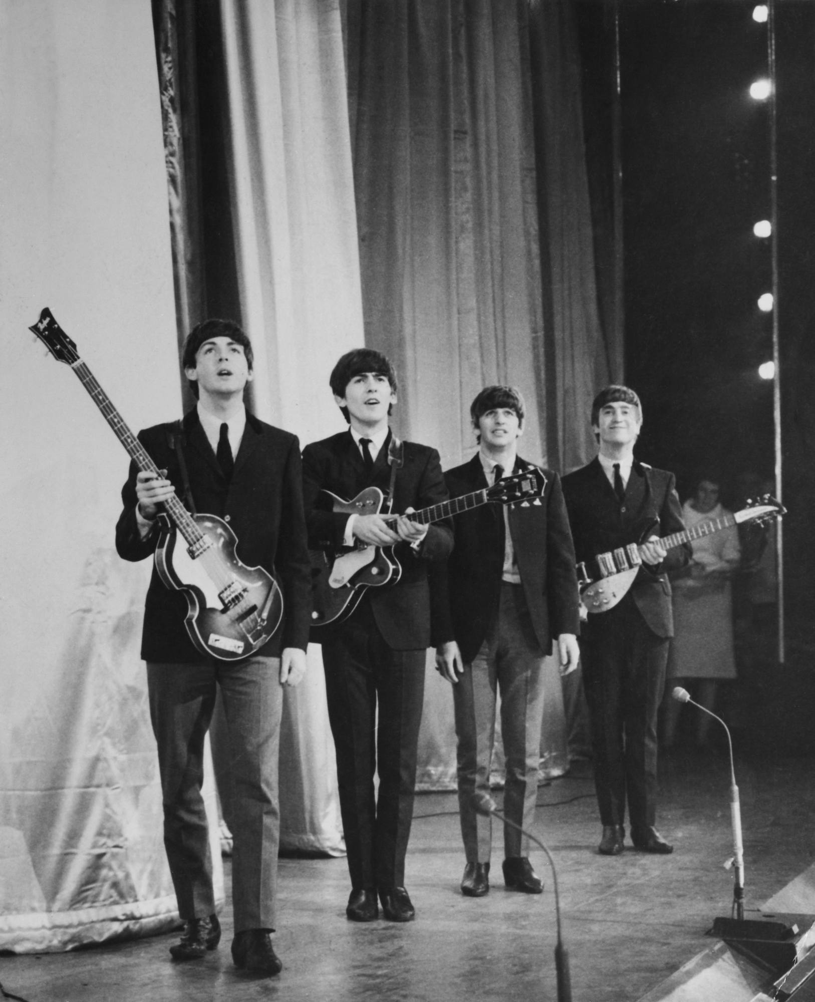 The Beatles take a bow on stage after performing in the Royal Command Performance
