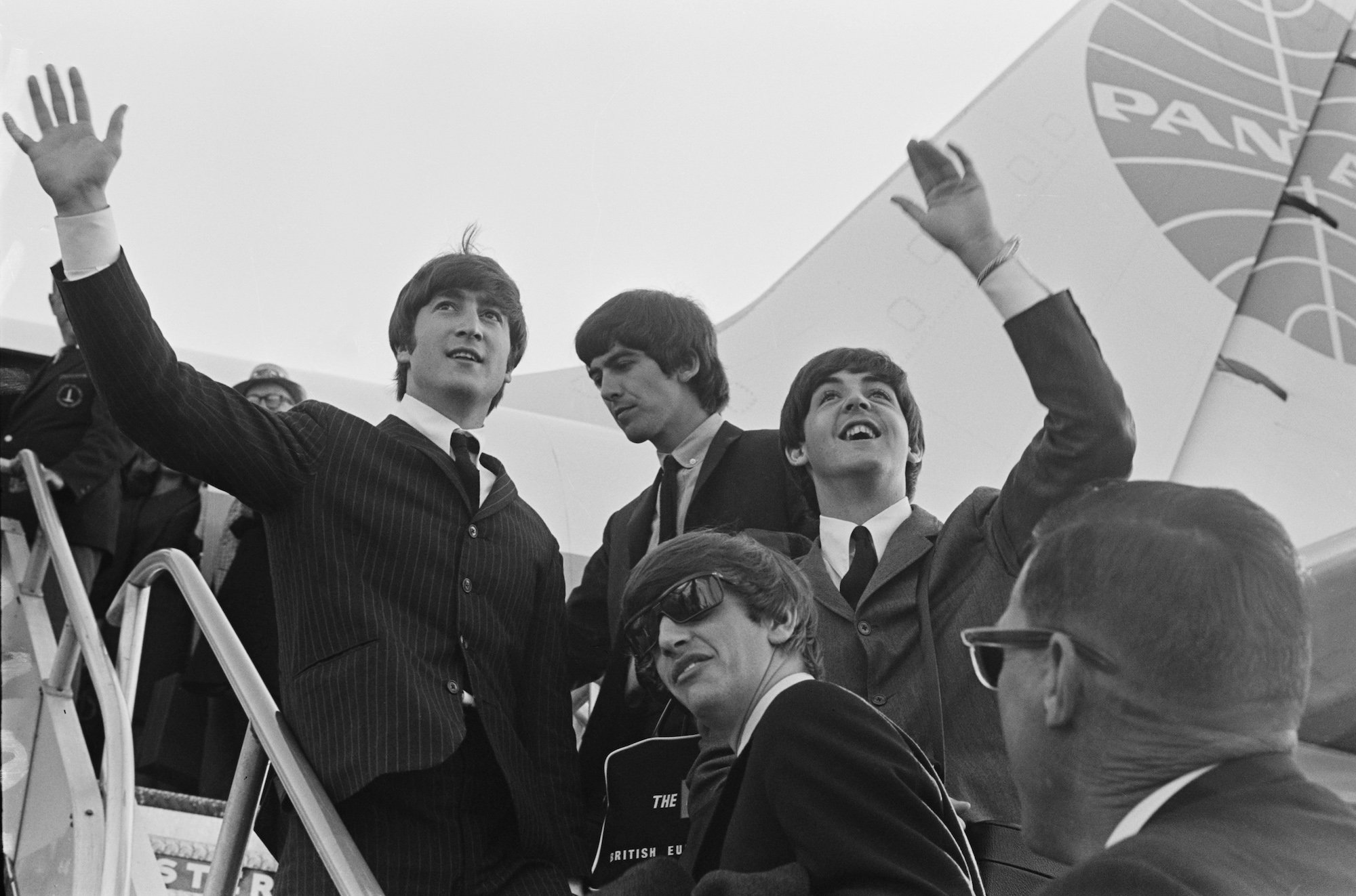 The Beatles wave at the crowd while in the US for their first US concerts