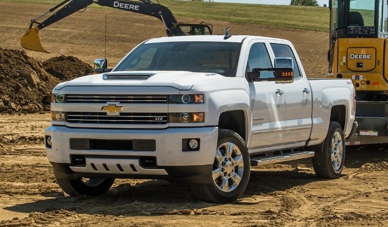 2018 Silverado 2500 HD White LTZ Custom Sport Crew Cab towing John Deere Compact Track Loader with a Big Tex Trailer. Towing 11,485 pounds (total weight of trailer and equipment combined).