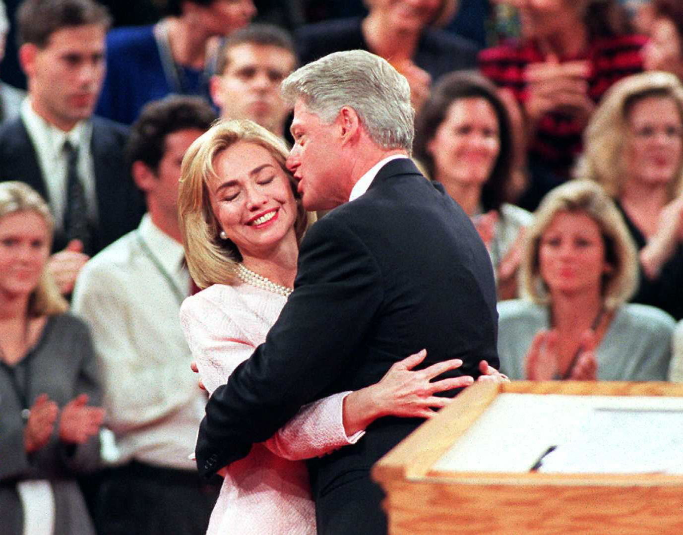 President Bill Clinton (R) gets a hug from Hillary Clinton