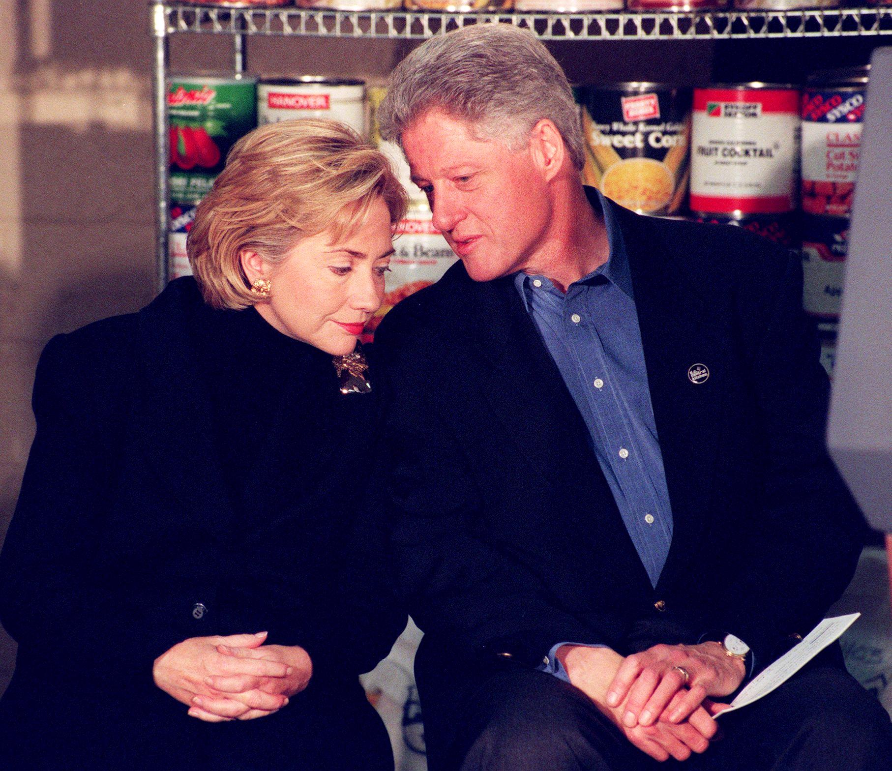 Bill Clinton (R) and First Lady Hillary Clinton (L) prepare to speak 