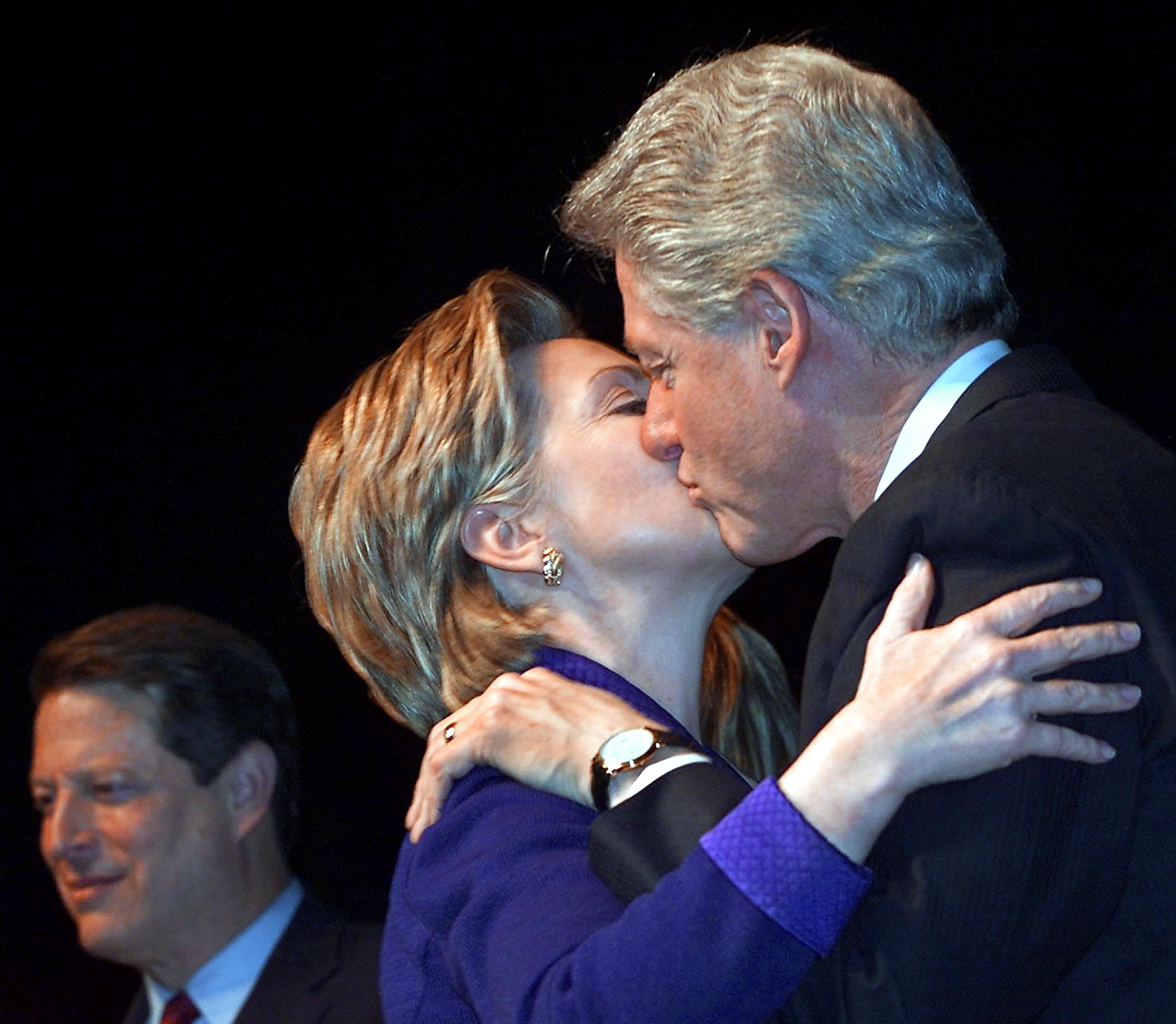 Bill and Hillary Clinton kiss beside Al Gore Bill and Hillary Clinton kiss beside Al Gore