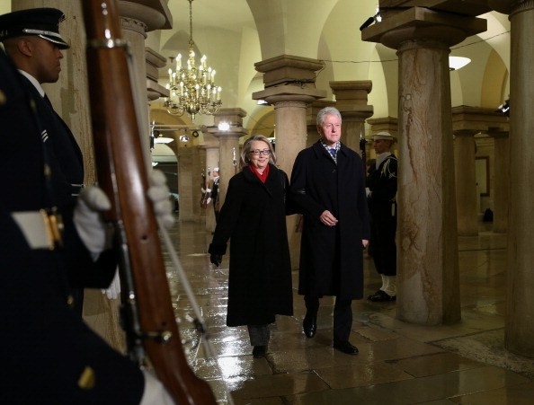Bill Clinton and Hillary Clinton walk through the crypt