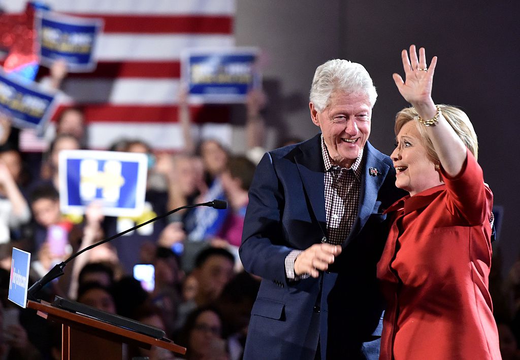 Democratic presidential candidate Hillary Clinton (R) and husband Bill Clinton (L) wave