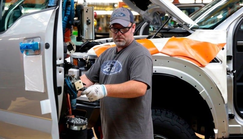 An employee works on the assembly line for Ford.