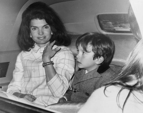 Jacqueline Kennedy in a car with one of her nephews (son of her sister, Princess Radziwill). She is stopping over in London on her way home after a visit to Spai