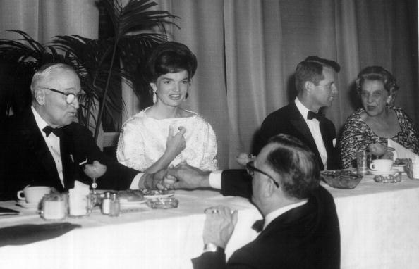 First Lady Jackie Kennedy sits with former president Harry S. Truman and Robert F. Kennedy during a ceremony at the White House January 20, 1962 in Washington, DC.