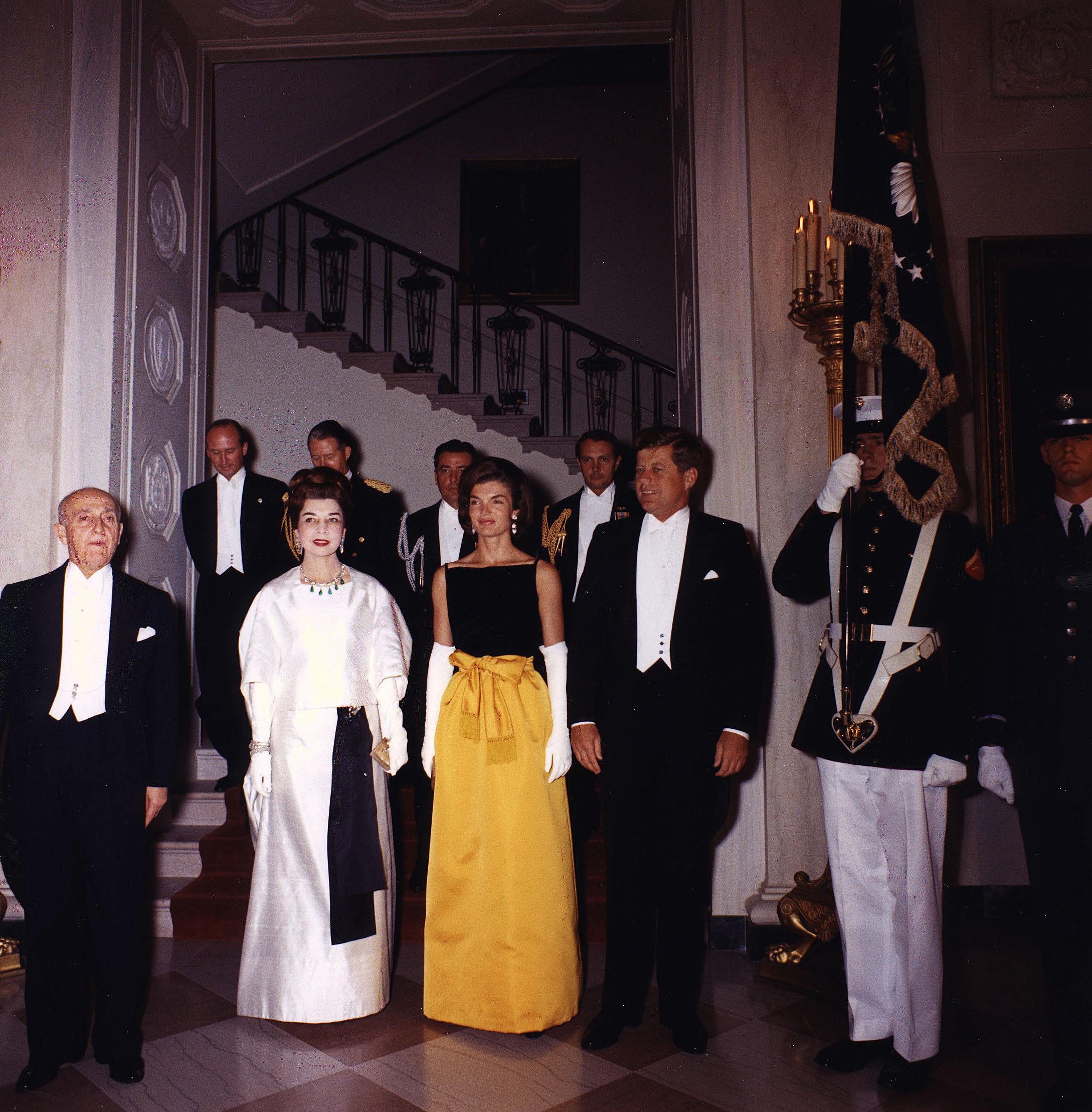 President John F. Kennedy and Jacqueline Kennedy, right, pose for a photograph with guests before a dinner in honor of the President of Peru, left, at the White House September 19, 1961 in Washington, DC