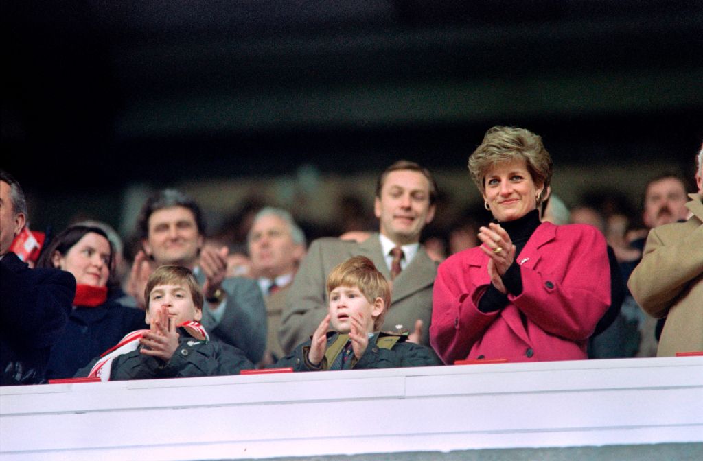 Diana, Princess of Wales, (R), Princes William (L) and Harry applaud during the Wales vs France Five Nations Cup match at Cardiff Arms Park on February 1, 1992 