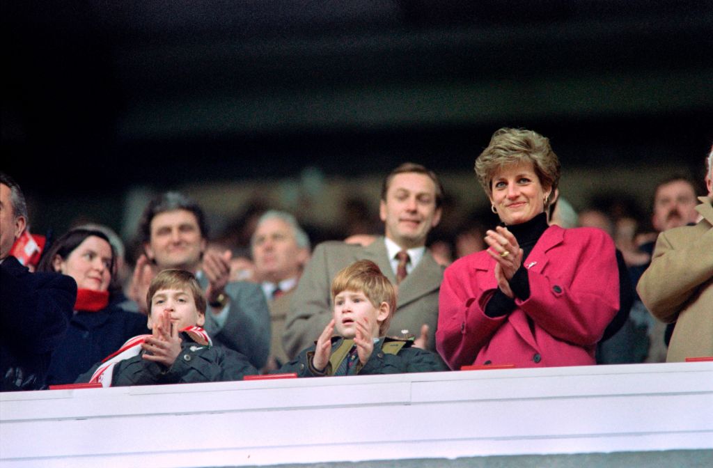 Diana, Princess of Wales, (R), Princes William (L) and Harry applaud during the Wales vs France Five Nations Cup match at Cardiff Arms Park on February 1, 1992