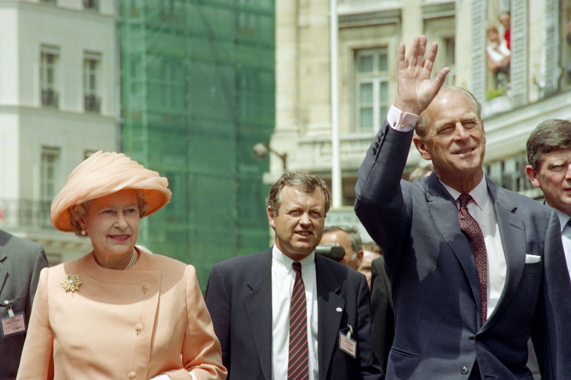 Queen Elizabeth II and Prince Philip wave as they walk to the Elysee Palace in Paris on June 9, 1992
