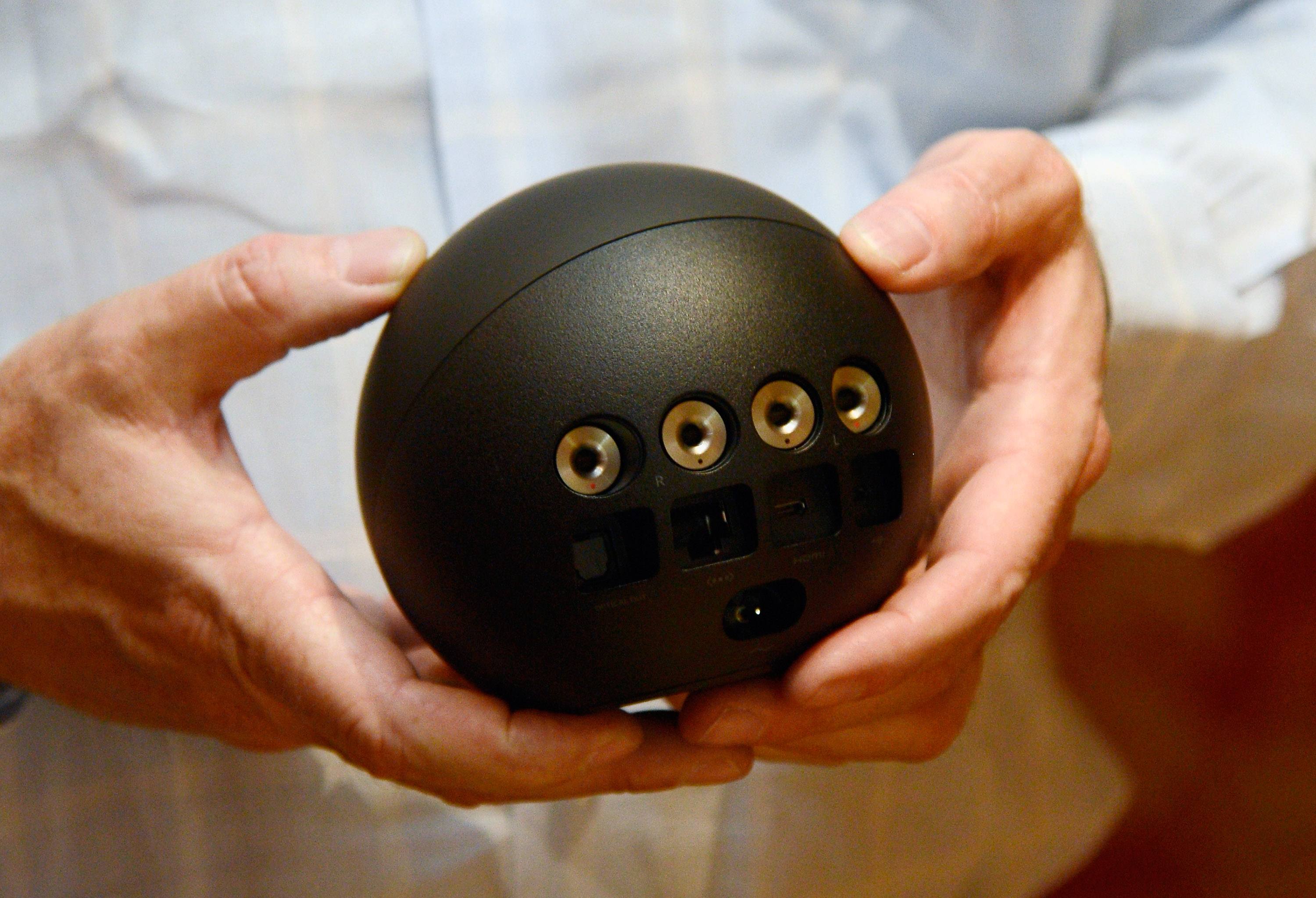 Man holding Google Nexus Q, one of the worst failed products in the tech sector