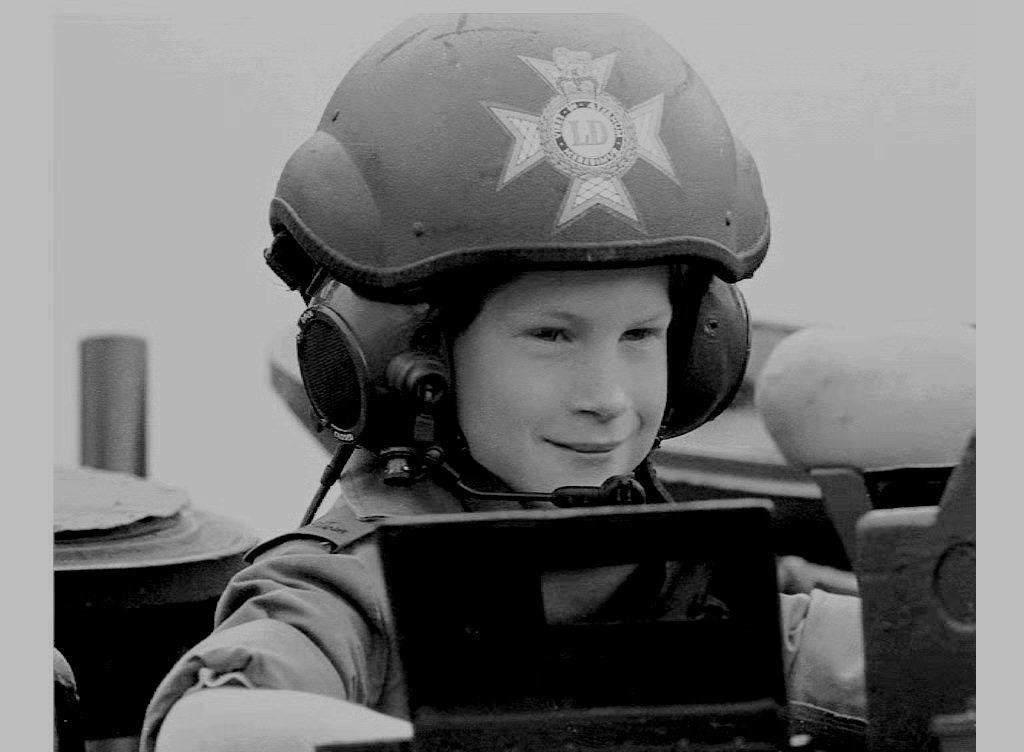 Britian's Prince Harry, youngest son of the Prince and Princess of Wales, wearing full dress uniform rides in a light tank during a visit to the British regiment of the Light Hussars in Hanover, NH, 29 July 1993 with his mother, Princess Diana