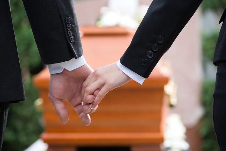 Holding hands at a funeral