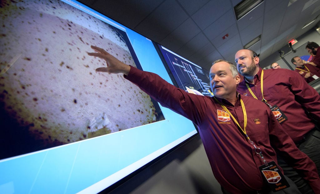 Tom Hoffman, project manager of NASA's Mars InSight landing, points to the landing site.