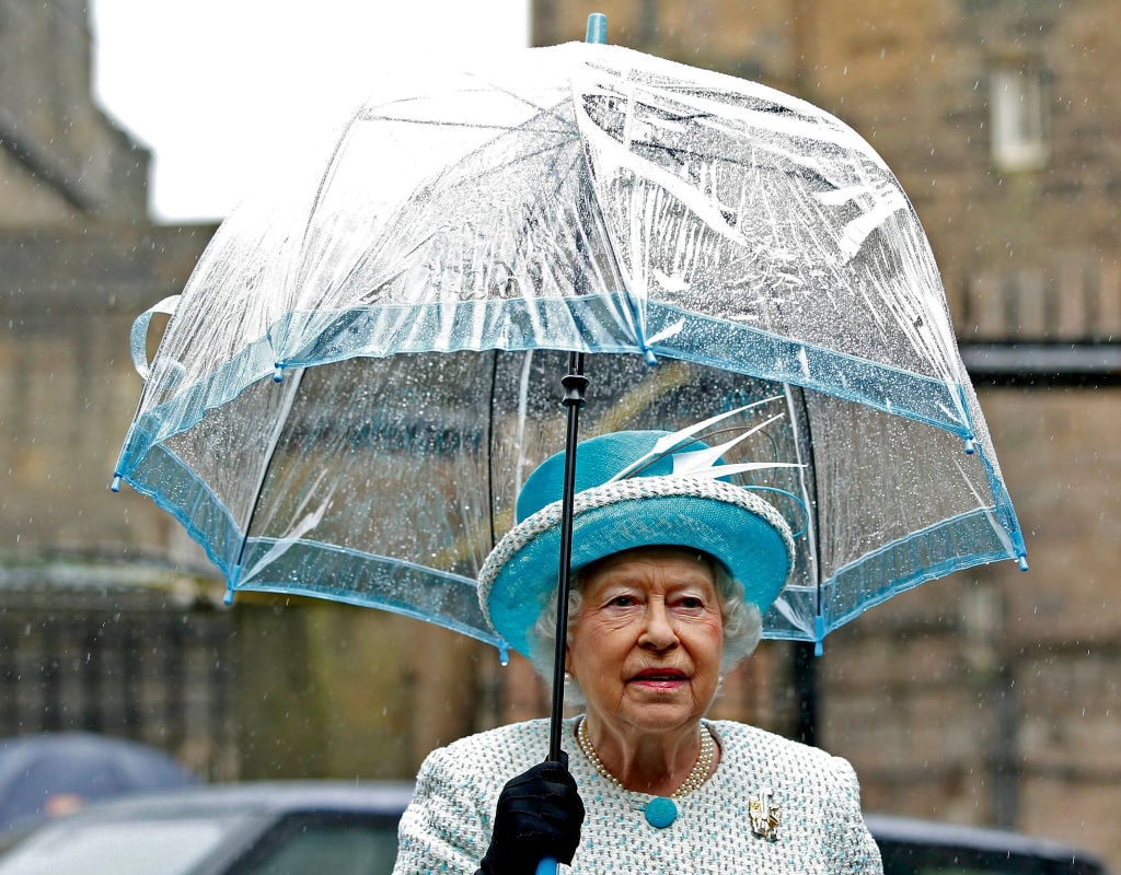 Queen Elizabeth with a blue bird cage umbrella