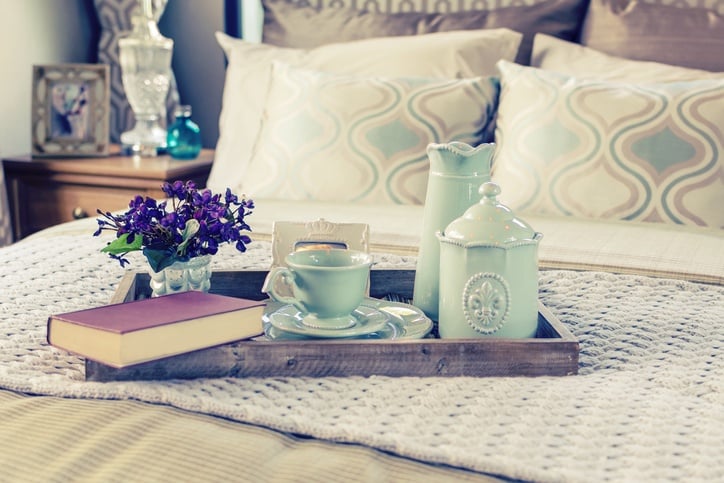 Tray Decorative tray with book,tea set and flower on the bed