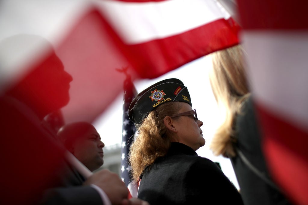A female veteran looks on during a news conference