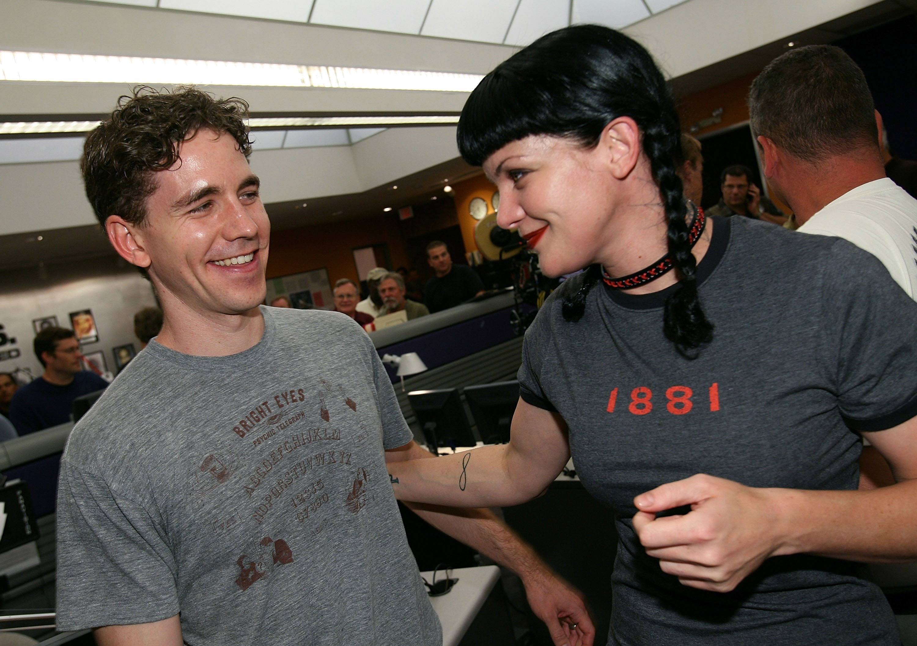 NCIS actors Brian Dietzen and Pauley Perrette celebrate the show's 100th episode in 2007