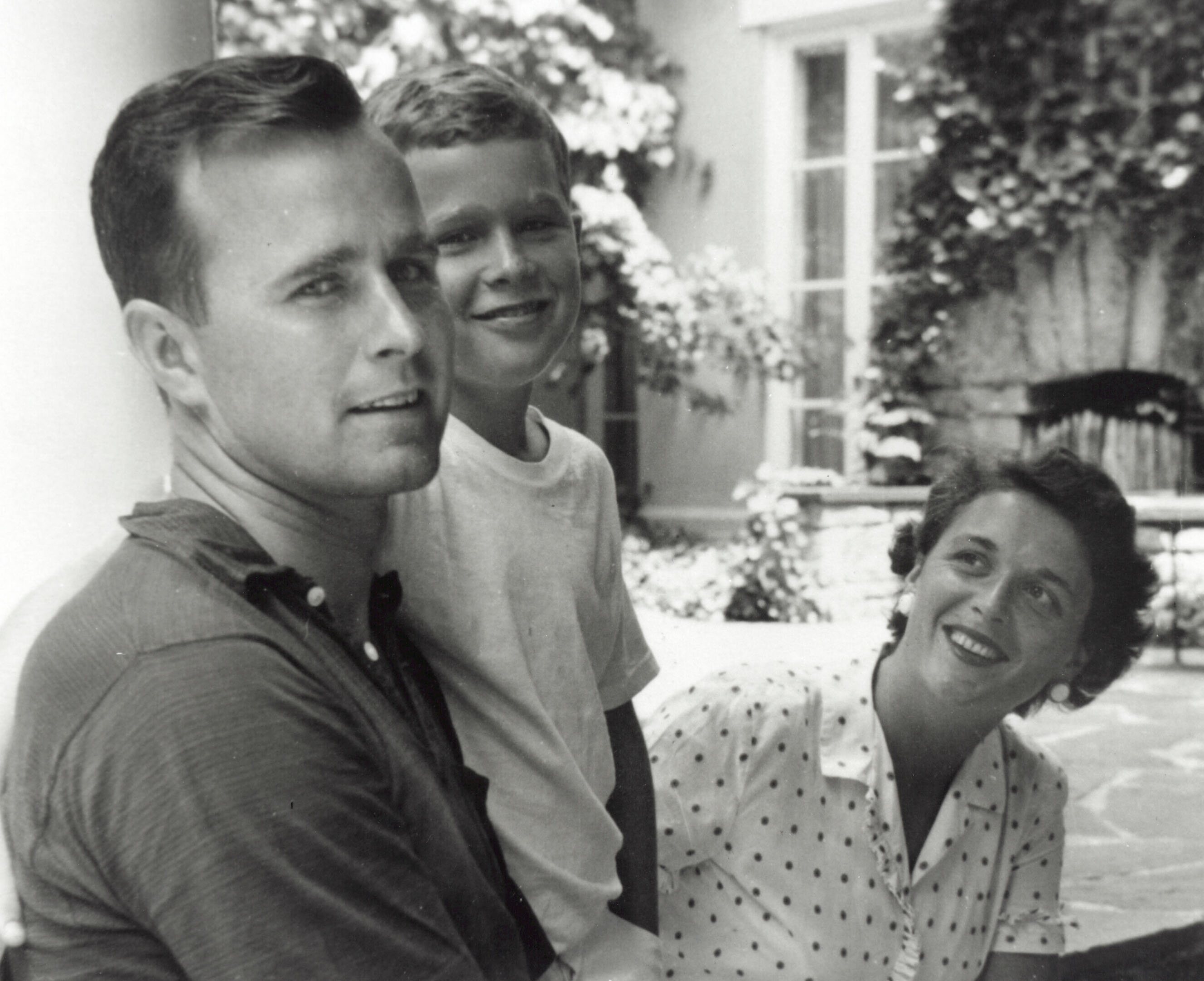 George W. Bush (C) poses with father George H.W. Bush and his mother Barbara Bush in Rye, New York, summer 1955