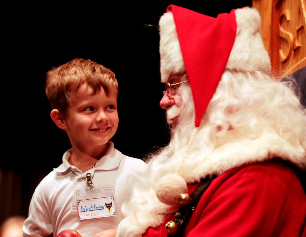 Child looks adoringly at Santa Claus