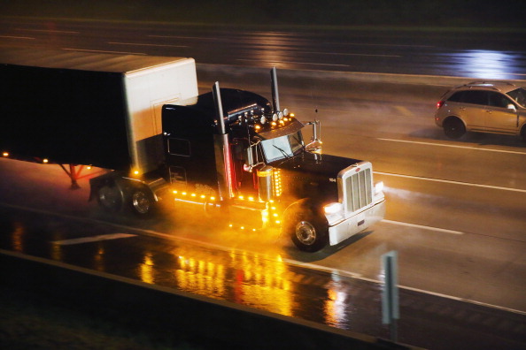 Tractor trailer driving in the rain