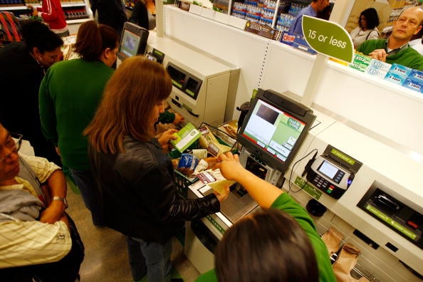 Shoppers using self checkout stations