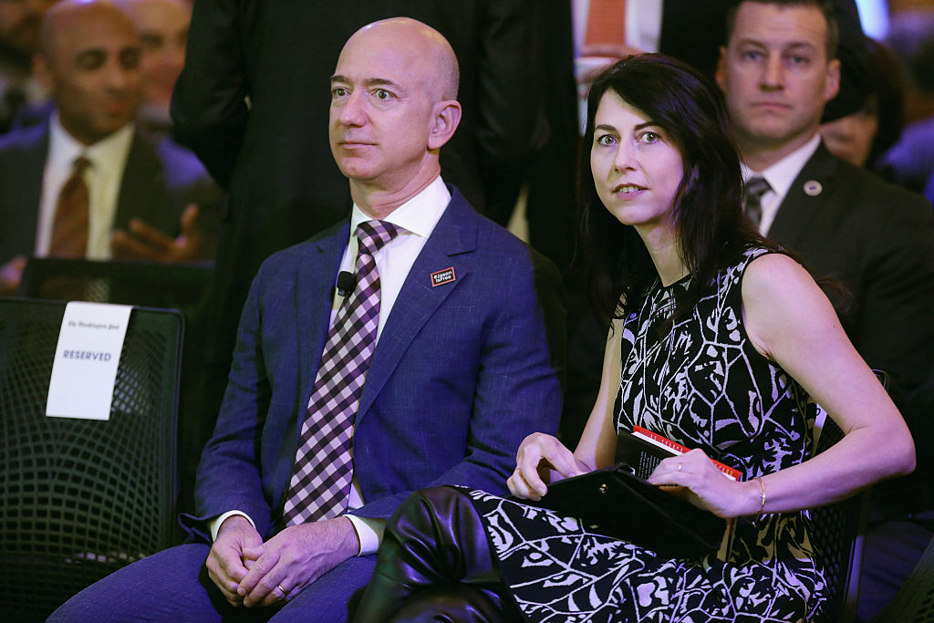 Jeff Bezos and his wife MacKenzie Bezos participate in the opening ceremony of the newspaper's new location January 28, 2016 in Washington, DC. Bezos purchased the newspaper and media company in October of 2013 from the storied Graham family. 