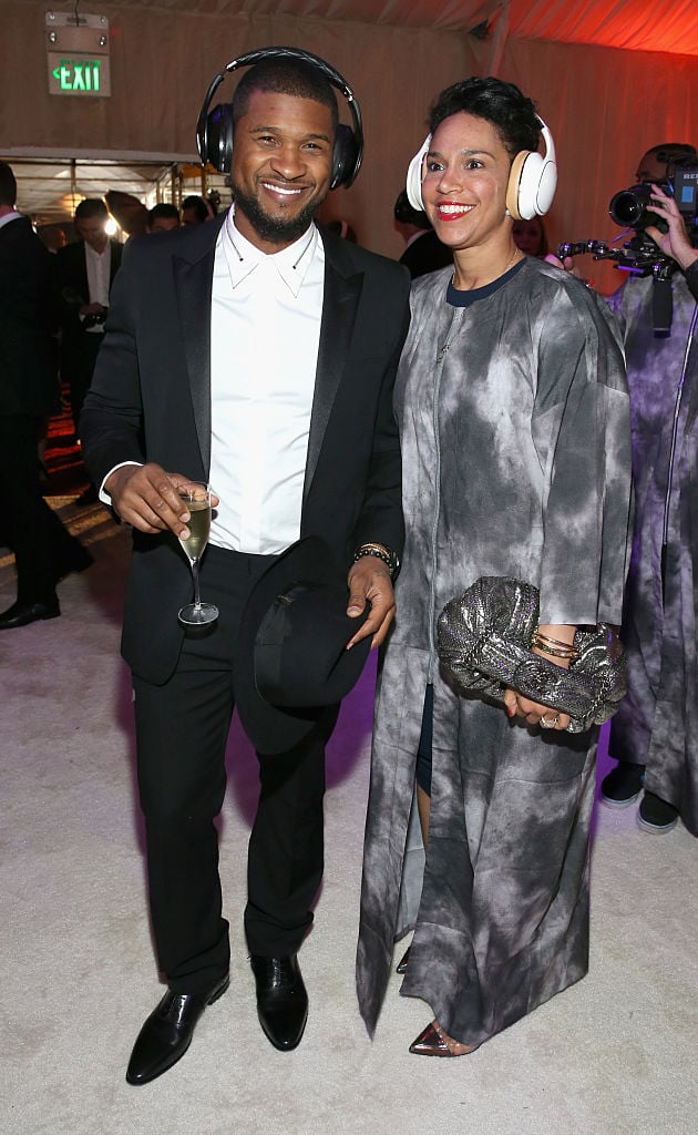 Usher (L) and Grace Miguel, wearing Samsung Level headphones, attend the 8th Annual HEAVEN Gala presented by Art of Elysium and Samsung Galaxy at Hangar 8 on January 10, 2015 in Los Angeles, California. 