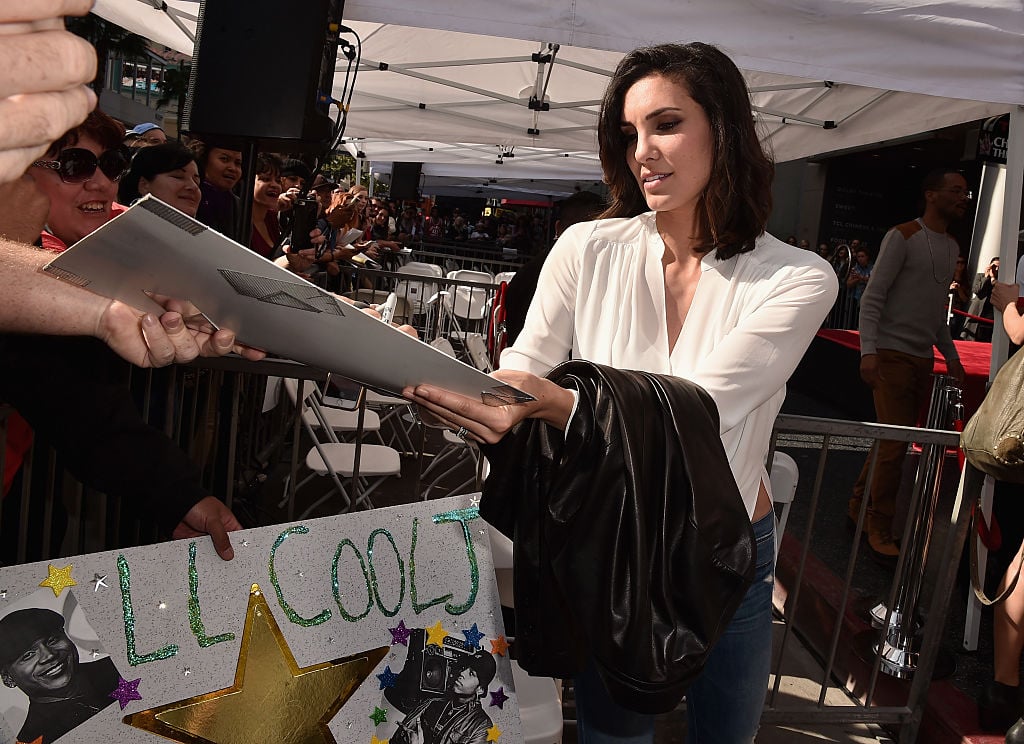 NCIS: Los Angeles actress Daniela Ruah signs autographs.