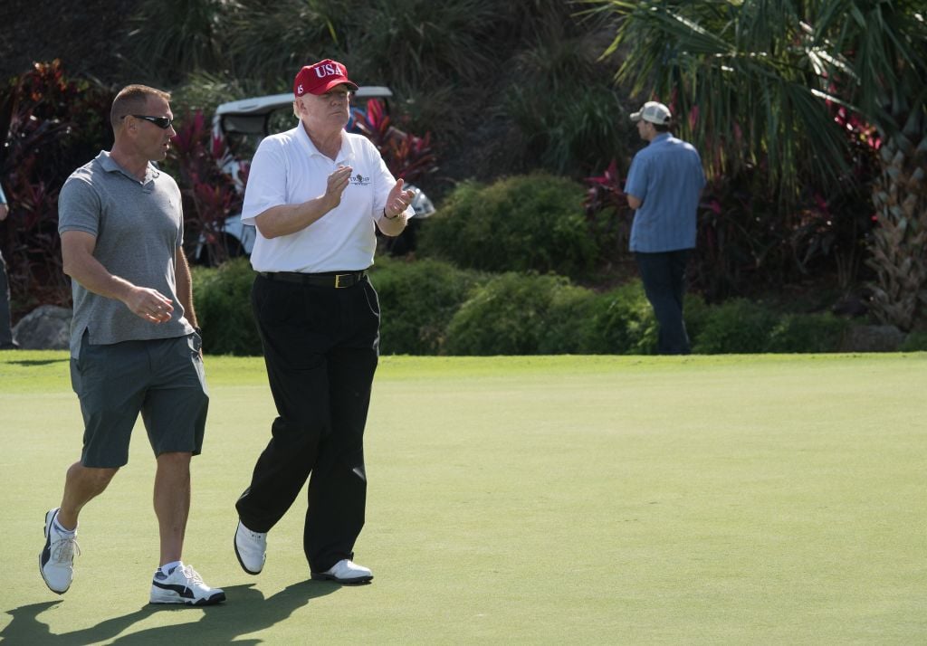 Donald Trump with US Coast Guard Chief Warrant Officer Gene Gibson| Nicholas Kamm /AFP/Getty Images