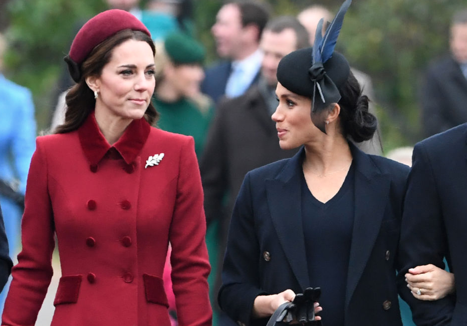 Kate Middleton and Meghan Markle talking to each other.