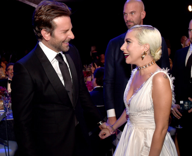 Bradley Cooper laughing with Lady Gaga