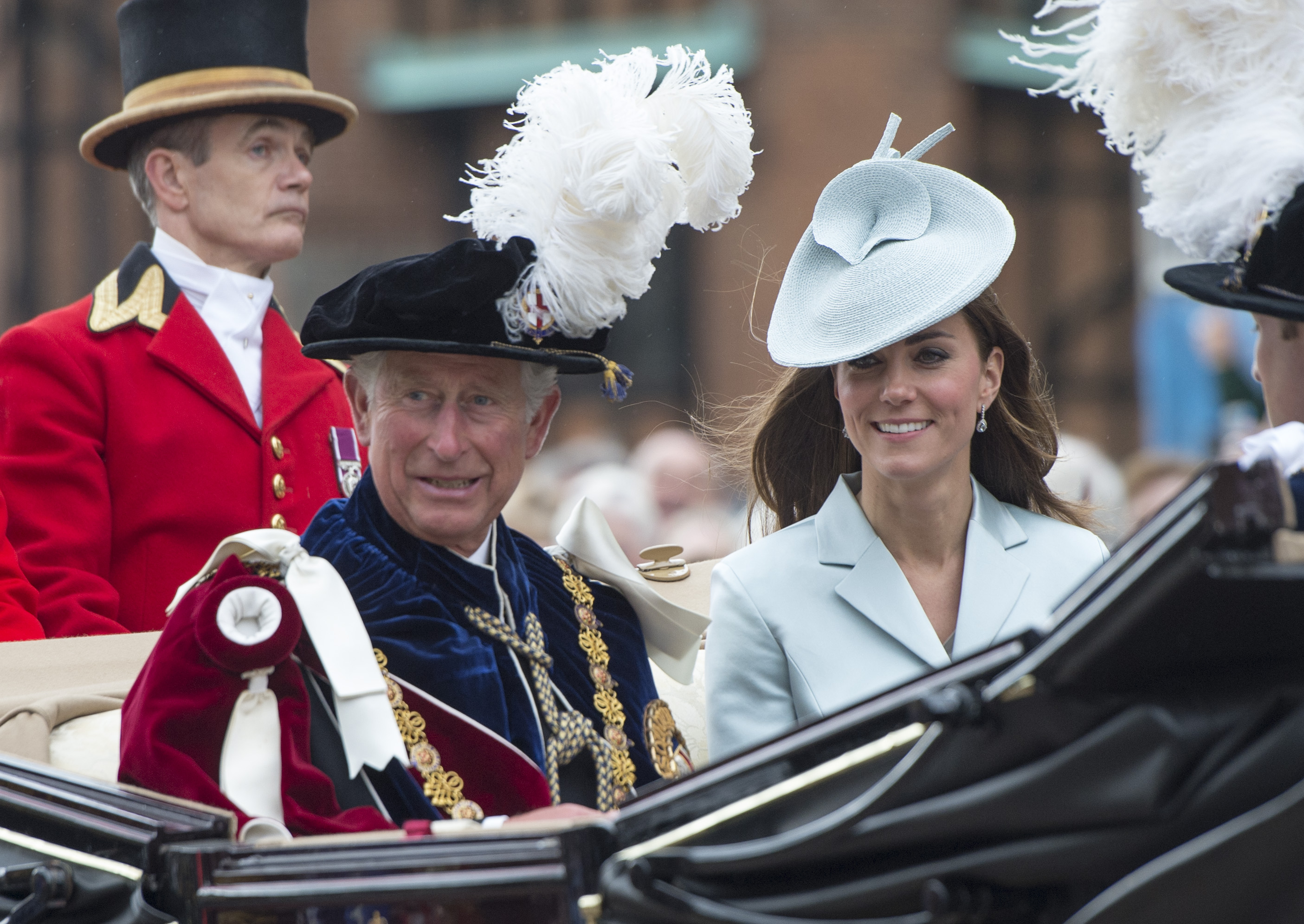 Prince Charles and Kate Middleton sit in a carriage together.