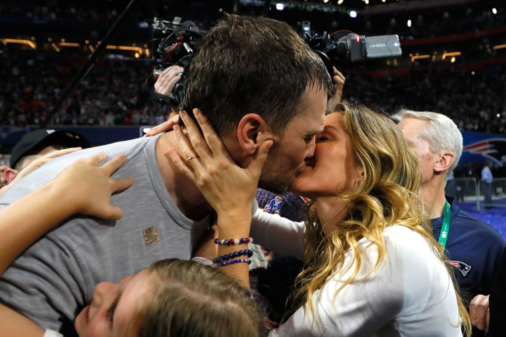 Tom Brady #12 of the New England Patriots kisses his wife Gisele Bündchen after the Super Bowl LIII against the Los Angeles Rams at Mercedes-Benz Stadium on February 3, 2019 in Atlanta, Georgia. The New England Patriots defeat the Los Angeles Rams 13-3.  