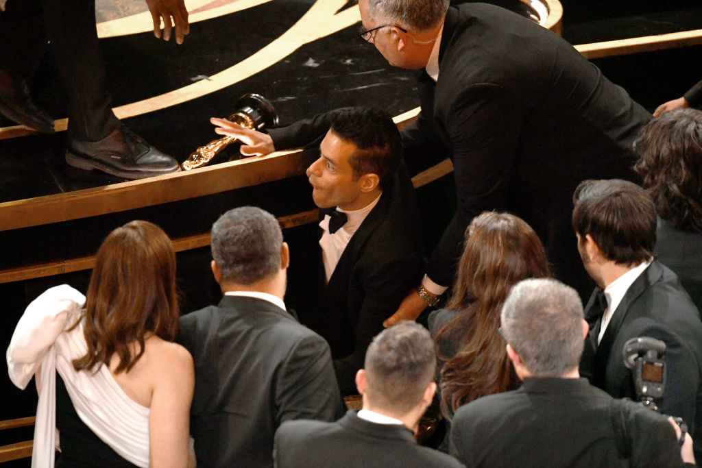 Rami Malek falls off stage following acceptance of 2019 Oscar for Best Actor.