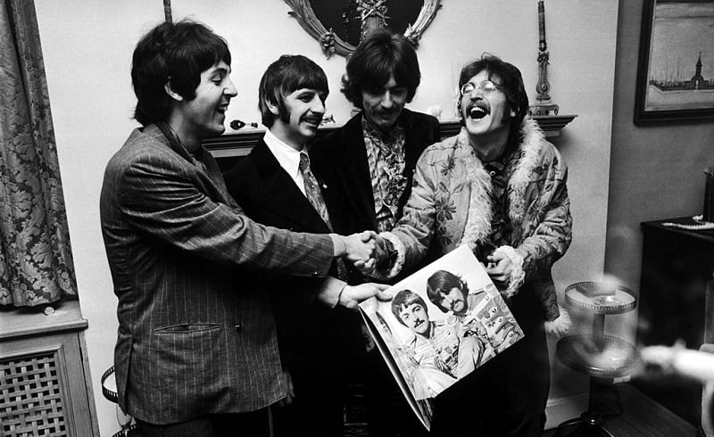 The Beatles (left  to right) George Harrison (1943 - 2001), Ringo Starr, John Lennon (1940 - 1980) and Paul McCartney, hold the sleeve of their new LP, 'Sgt. Pepper's Lonely Hearts Club Band', at the press launch for the album, held at Brian Epstein's house at 24 Chapel Street, London, 19th May 1967.