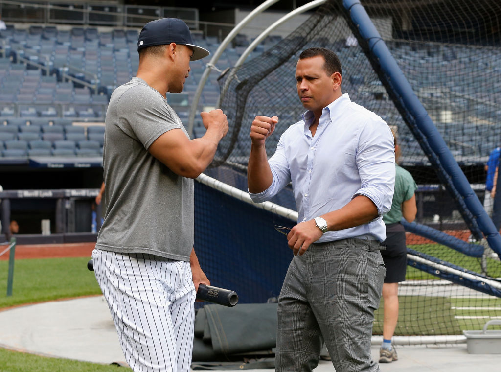Giancarlo Stanton #27 of the New York Yankees talks with Alex Rodriguez |  Jim McIsaac/Getty Images
