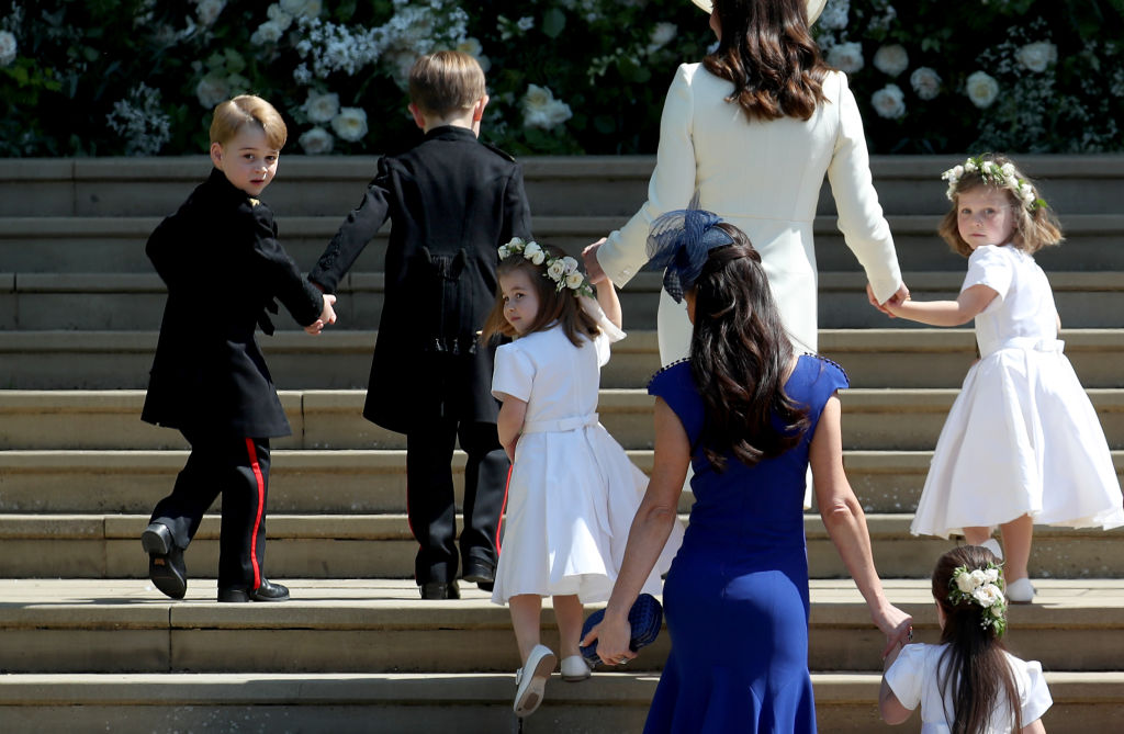 Prince George and Princess Charlotte walk up the steps at Prince Harry and Meghan Markle's royal wedding. 