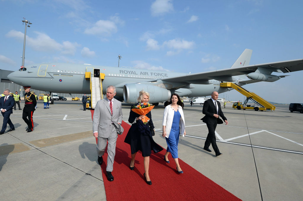 Prince Charles and Camilla walking away from a plane