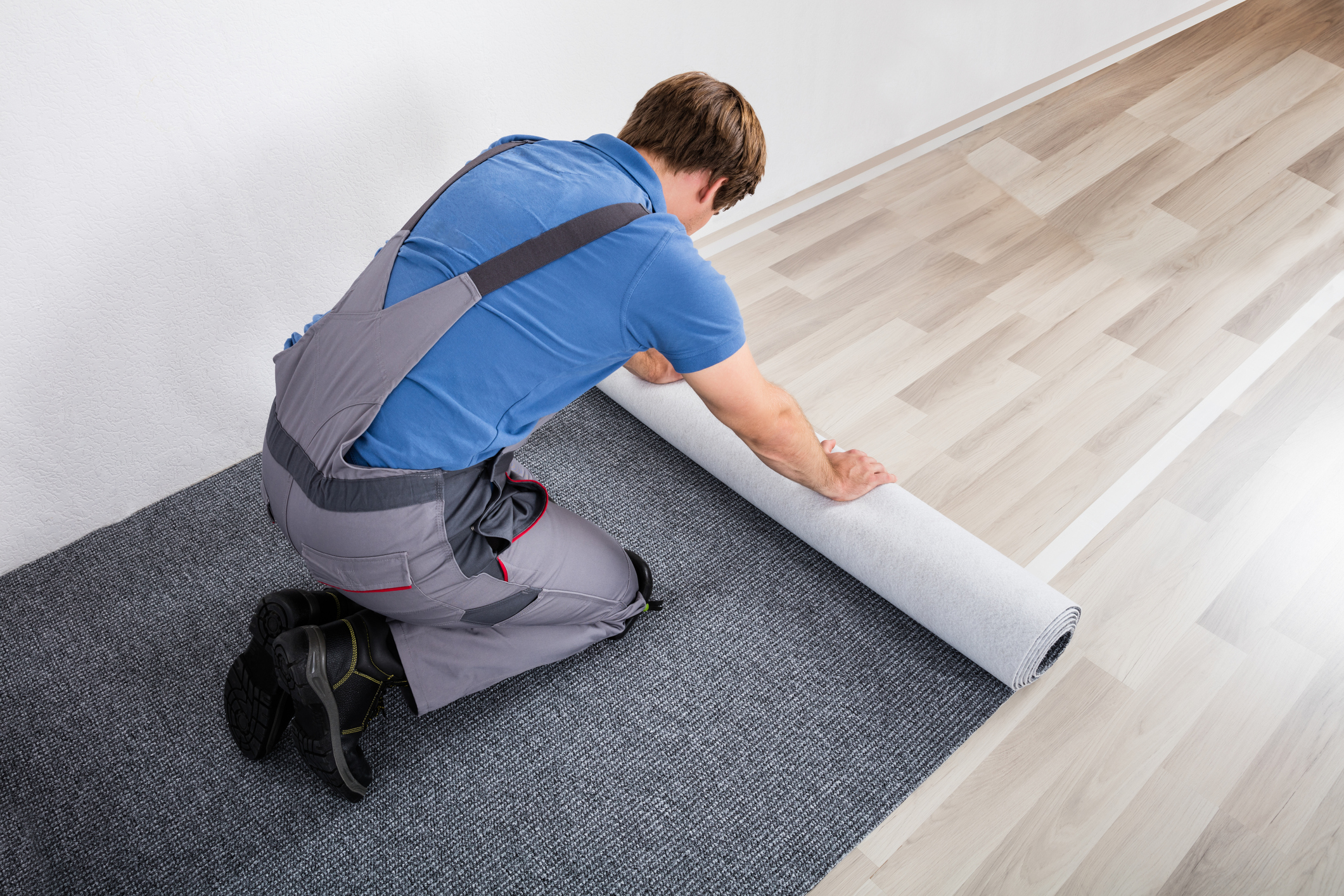 Handyman installing carpet