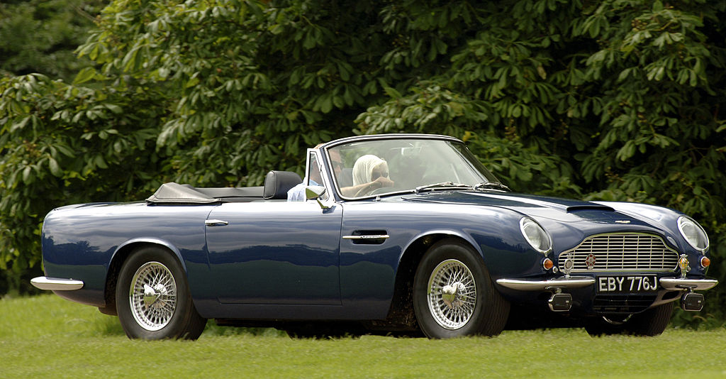 Prince Charles driving his vintage Aston Martin