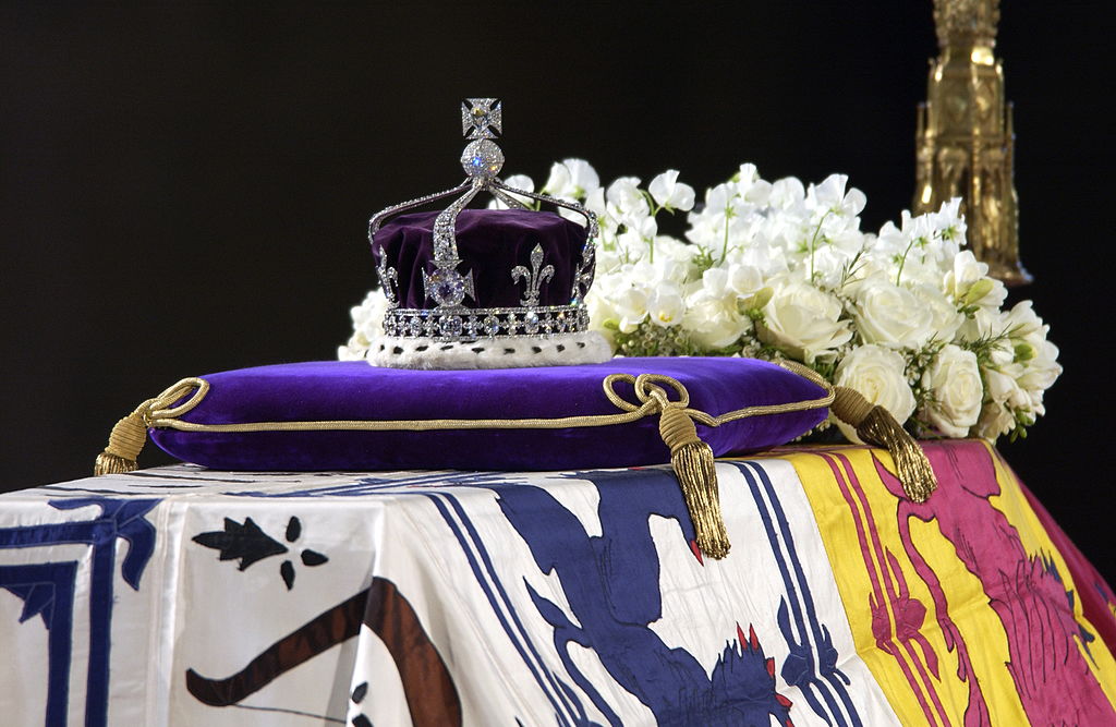 A close up of the coffin with the wreath of white fowers and the queen mother's coronation crown with the Koh-i-Noor diamond. 