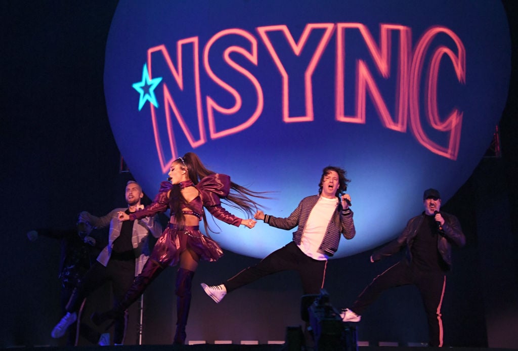 Ariana Grande (C) performs with members of NSYNC