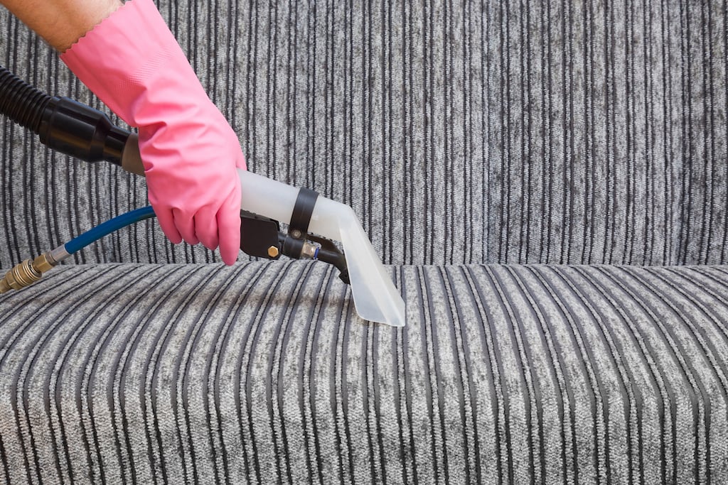 Vacuuming a modern sofa