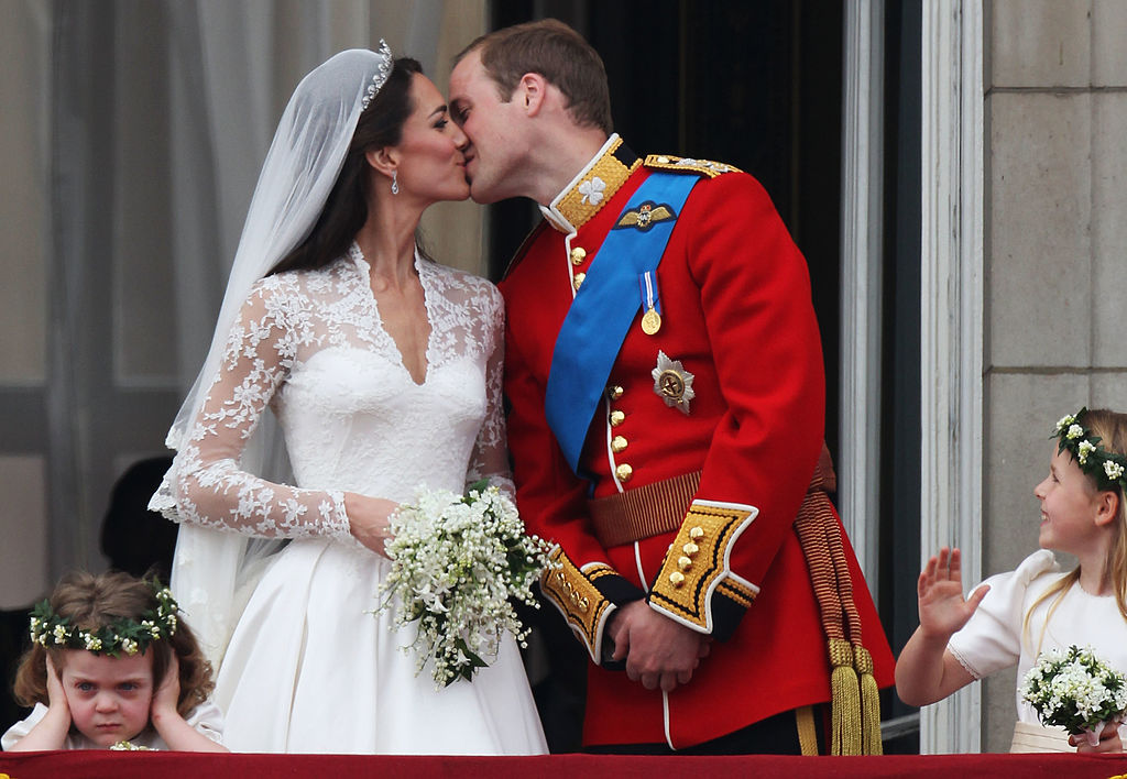 Kate Middleton and Prince William kissing on balcony at Buckingham Palace after wedding. 
