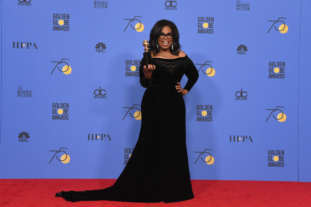 Oprah Winfrey at the Golden Globes holding Cecil B. DeMille award.