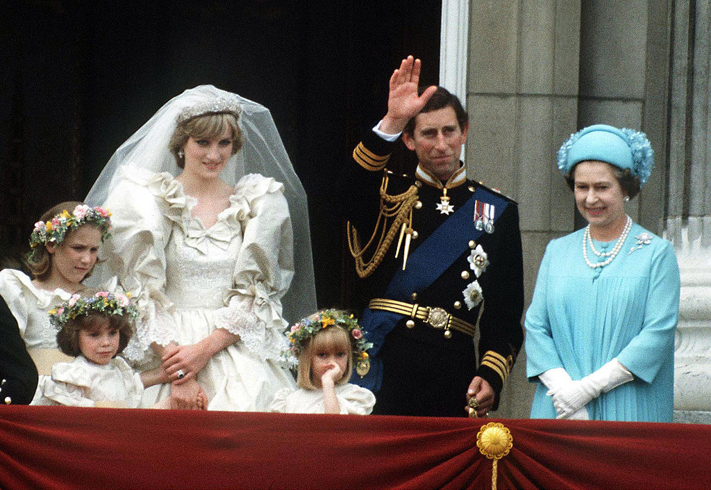 Princess Diana, Prince Charles, and Queen Elizabeth II on Buckingham Palace balcony during wedding.