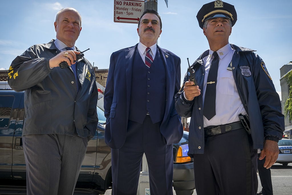 Tom Selleck on the set of Blue Bloods|Mike Pniewski, Tom Selleck, Esai Morales. (Photo By Jeff Neumann/CBS via Getty Images