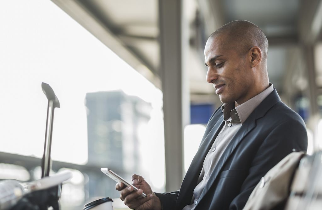 Businessman with phone at airport